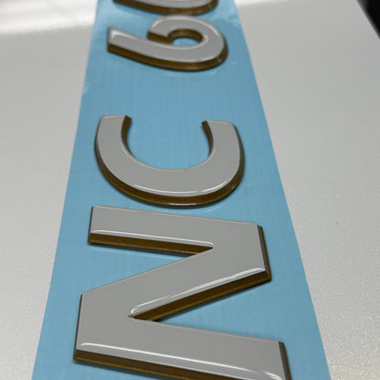 Tige Boats 3D Emblem with Domed Overlay Registration. Tige Stone and Dark Metallic Gold